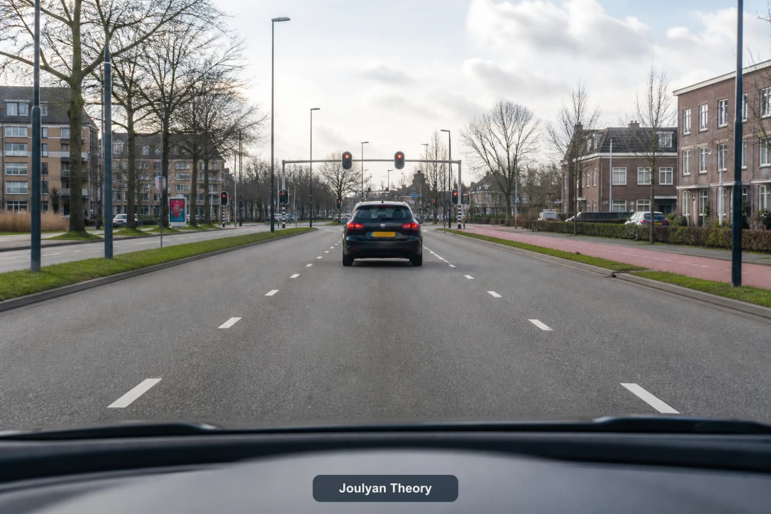 Driver view with a large following gap and red traffic lights in the distance