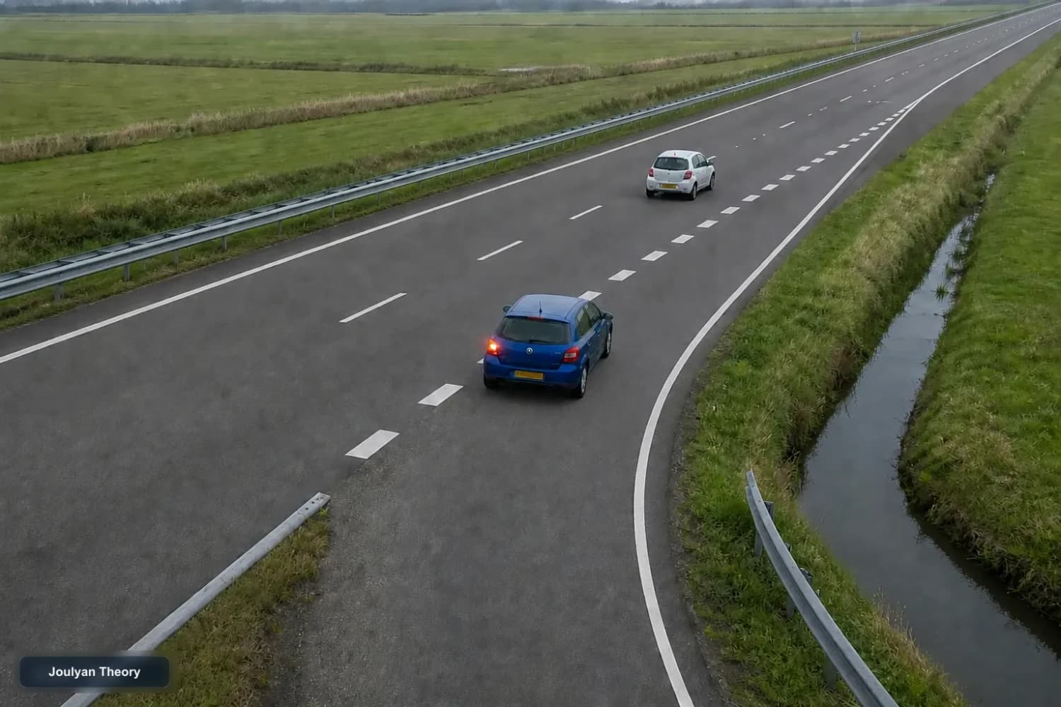 Blue car travels on an acceleration lane beside a white car on the through carriageway