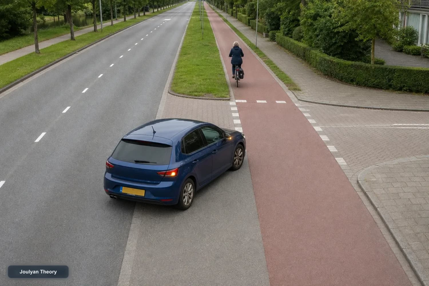 Car turns right across a separated red cycle path while a cyclist continues straight